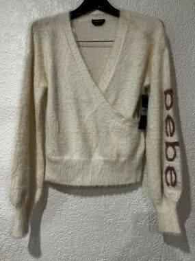 bebe Cream Fuzzy Wrap V-Neck Sweater with Logo Sleeve